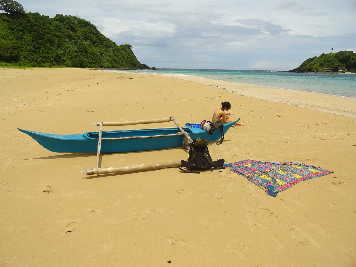 Long golden curve of Nacpan Beach near El Nido, one of the best beaches in Palawan