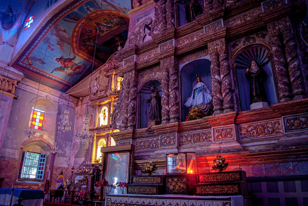 The ornate retablo inside Baclayon Church, one of the oldest stone churches in the Philippines