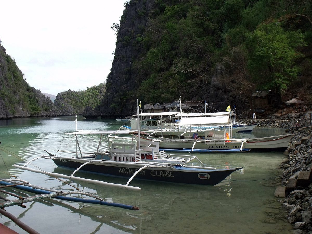 Wooden pier and clear water at Kayangan lagoon, Coron Island, Palawan