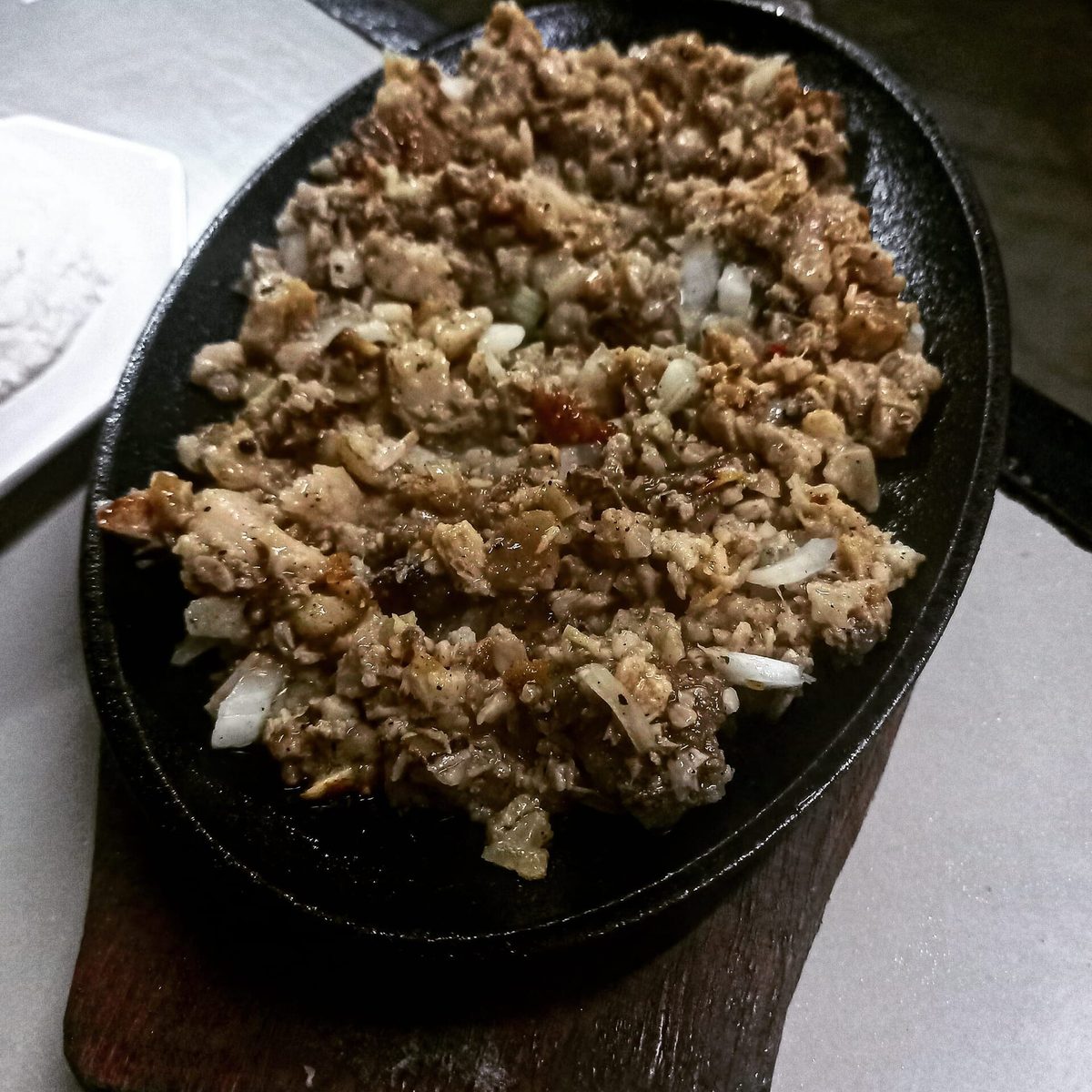 Sizzling pork sisig on a hot plate, a famous Kapampangan dish