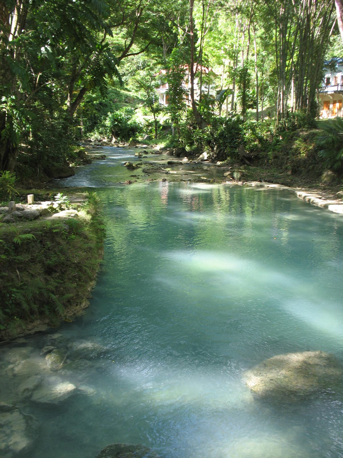 The blue river canyon leading down toward Kawasan Falls in Badian