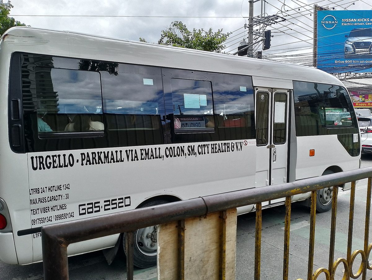 A modern jeepney in Cebu City, part of the Philippines PUV Modernization Program, with a boxy body and side door