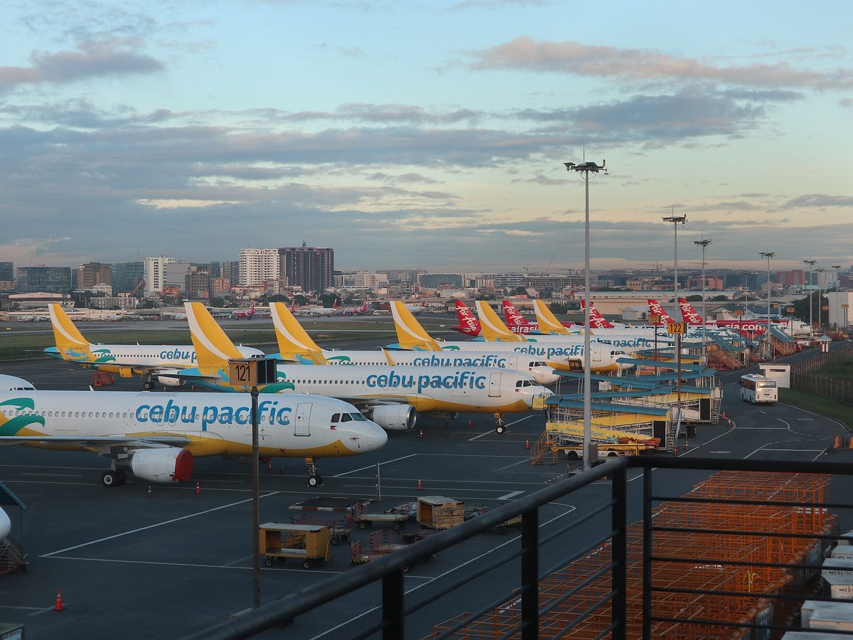 Cebu Pacific and AirAsia aircraft parked at NAIA Terminal 3 in Manila