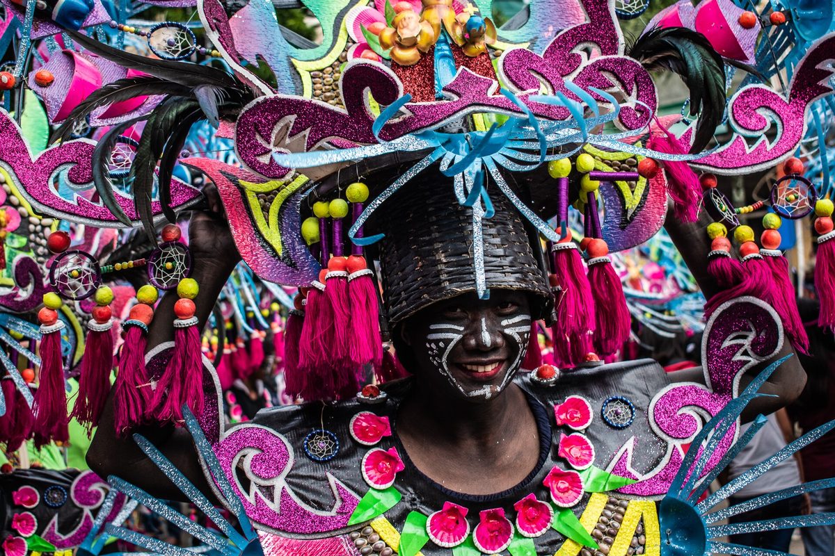 Soot-painted revelers in tribal costume at the Ati-Atihan Festival in Kalibo, Aklan