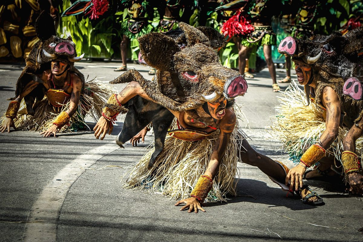 Ati warrior tribe performers in feathered headdresses at the Dinagyang Festival in Iloilo