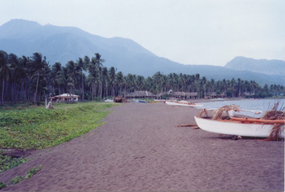 Volcanic black-sand beach and clear water on Camiguin island, the off-beat final stop