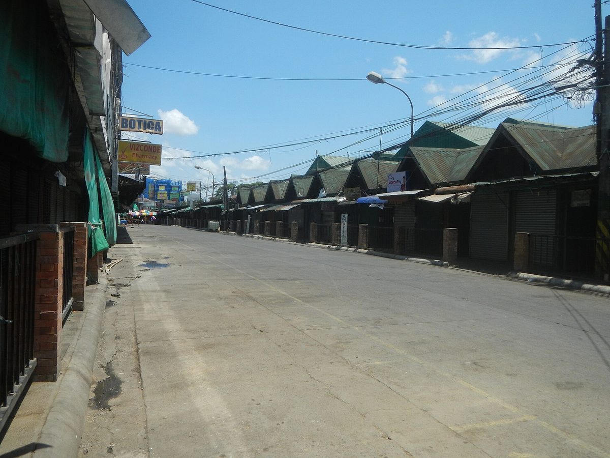 A shuttered Philippine public market street, the kind of local market and pharmacy where toiletries, slippers and other basics are cheap to buy on arrival
