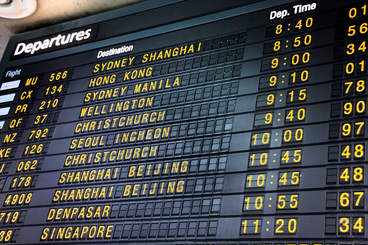 An airport departures board, a reminder that an onward or return ticket is part of Philippines visa-free entry for UK, Australian and Canadian travelers