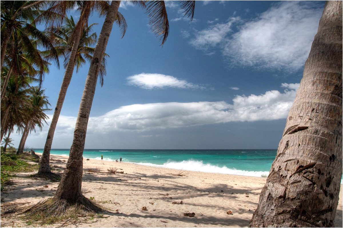 Puka Shell Beach on Boracay's quiet northern tip, with coarse sand and green hills