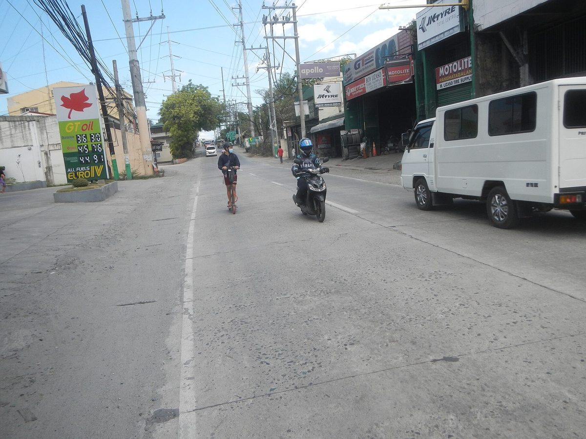 Scooters in everyday use on a Philippine street, the type widely available to hire