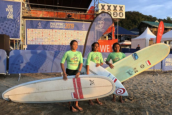 Surfers with their boards at San Juan, La Union, a top beginner surf spot in the Philippines