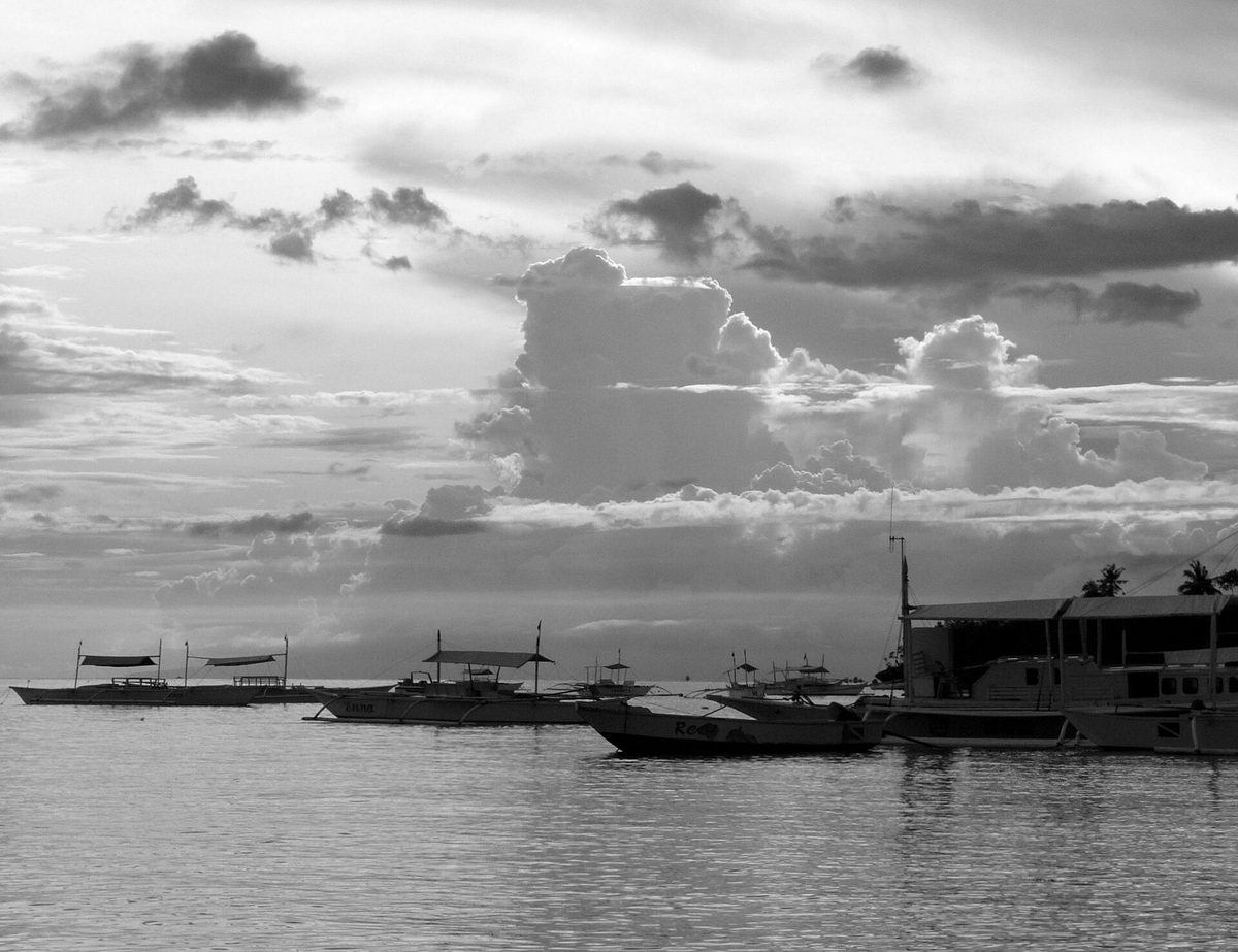 Alona Beach on Panglao Island with white sand and traditional bangka boats, a key spot for things to do in Bohol