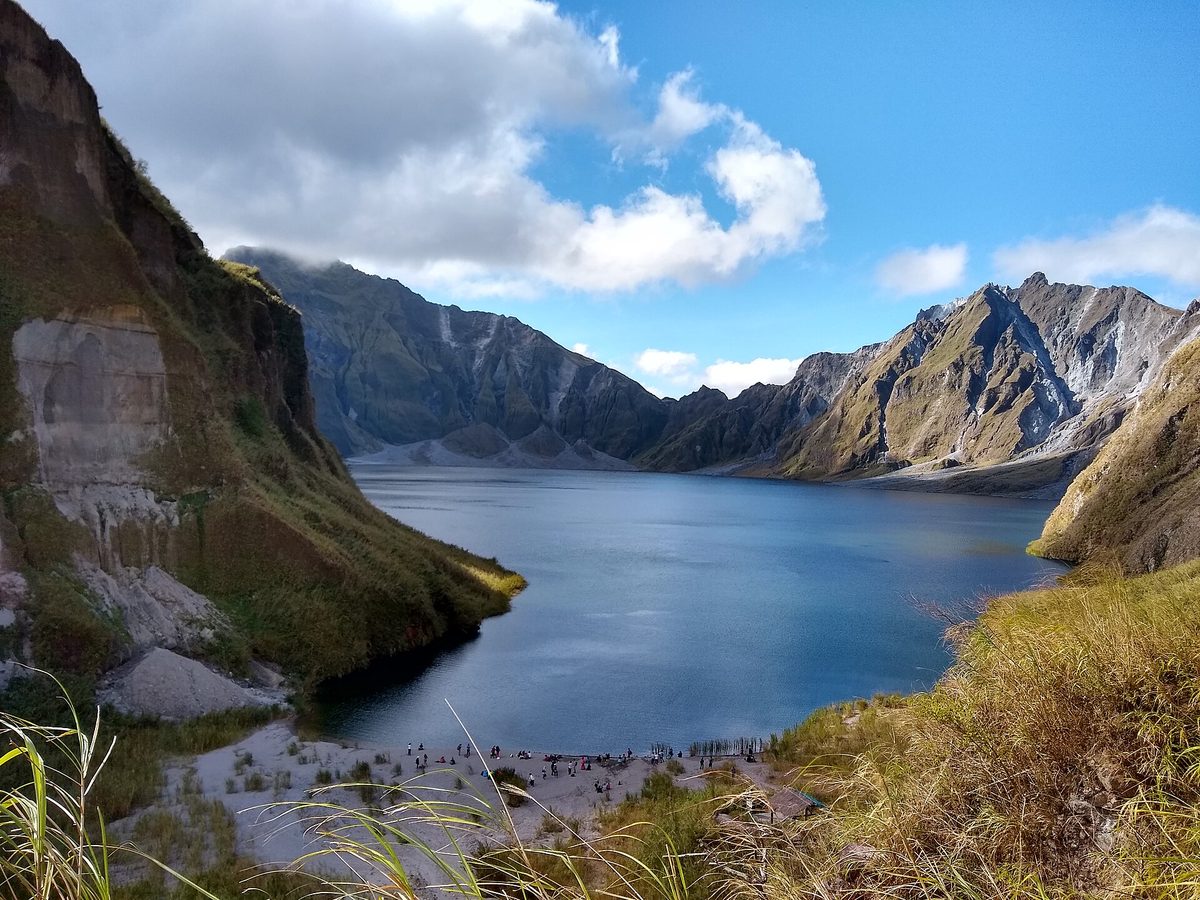 The turquoise crater lake of Mount Pinatubo ringed by steep ash walls