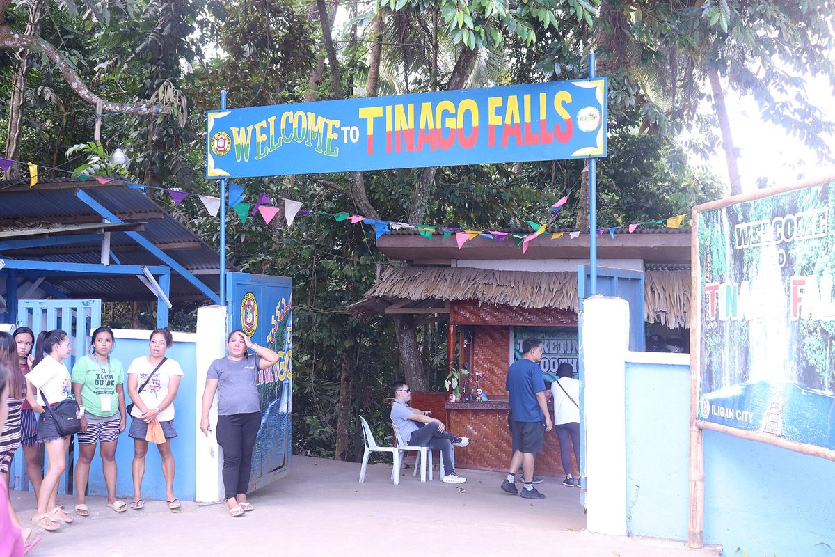 Tinago Falls plunging into a deep blue basin in a gorge near Iligan, Mindanao