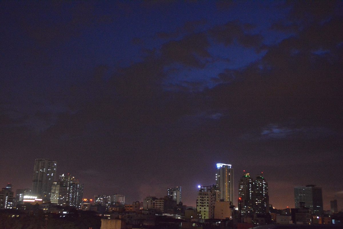 Metro Manila skyline lit up at night across the city's central business districts