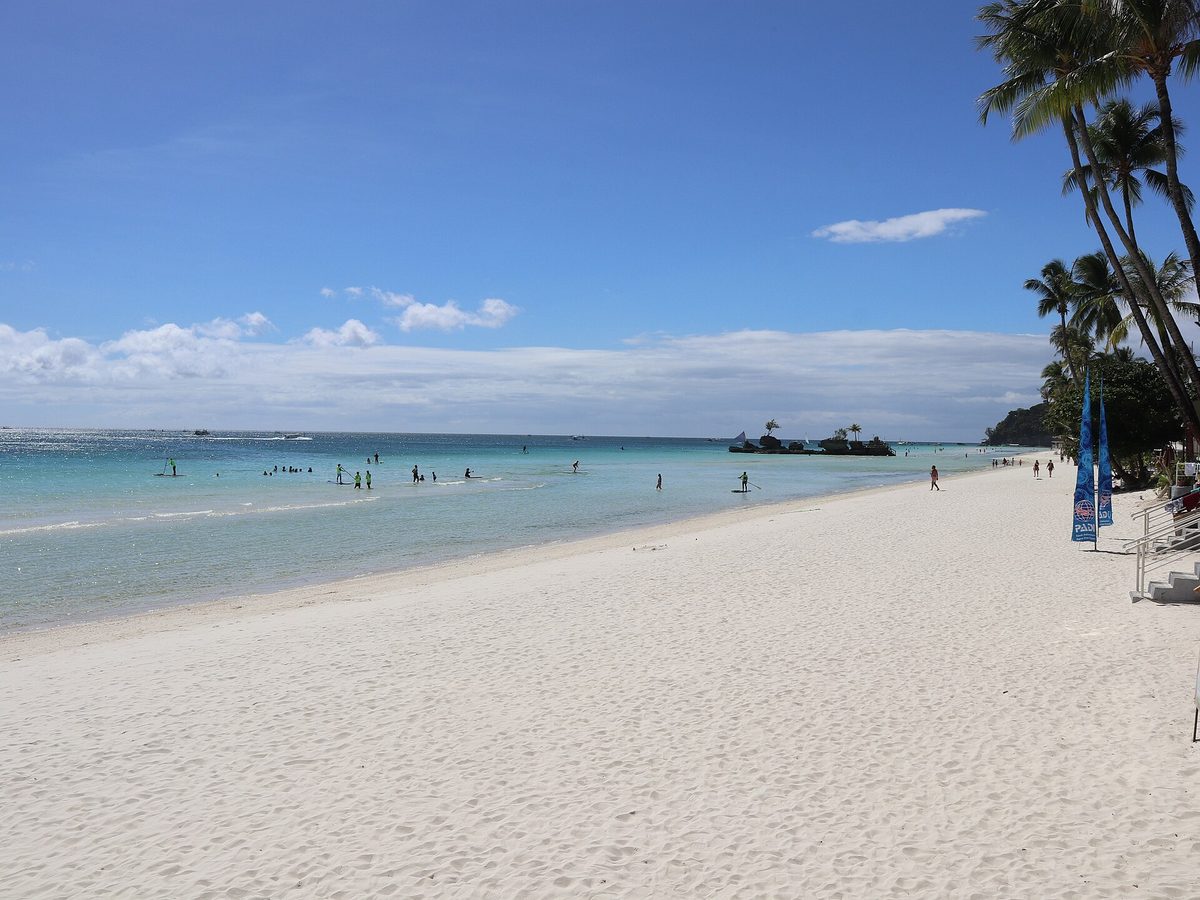 The wide stretch of fine sand and palm trees at Station 1 of White Beach, Boracay